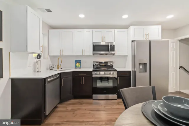 a kitchen with stainless steel appliances a refrigerator stove microwave and sink