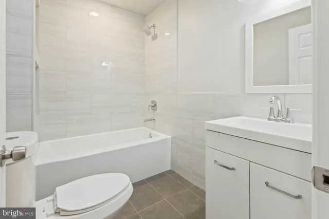 an empty room with a window and a ceiling fan