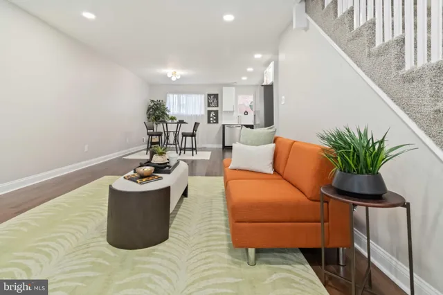 a living room with furniture and a potted plant