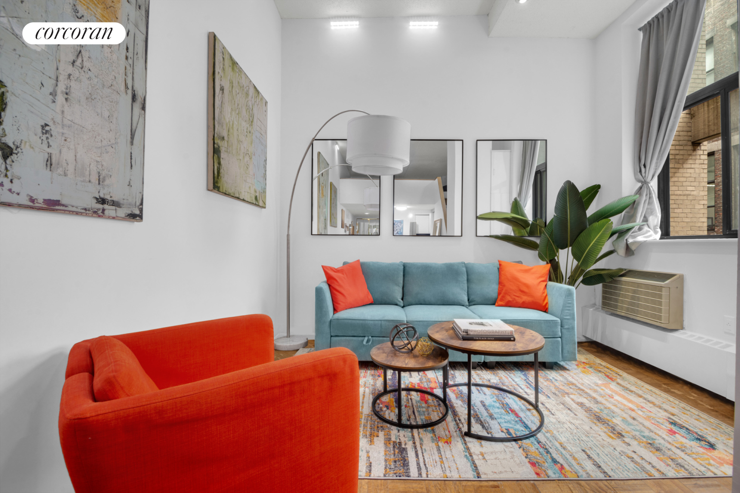 a living room with furniture and wooden floor