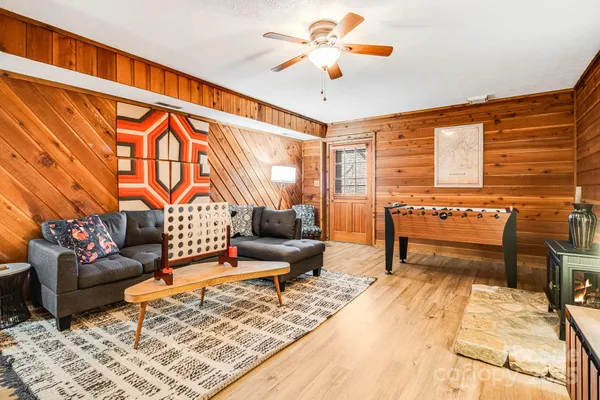 a living room with furniture a rug and a chandelier