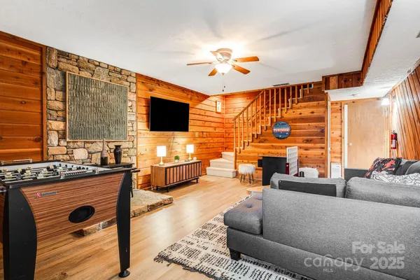 a living room with fireplace furniture and a flat screen tv