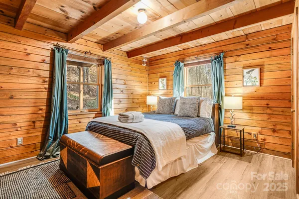 a bed sitting in a bedroom next to a window