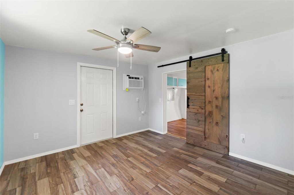 2092 Culbreath Road, Unit C52 Brooksville, FL 34602 - Photo 18 of 33 wooden floor in an empty room with a chandelier fan
