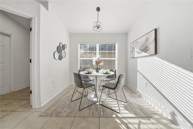 a dining room with furniture and window