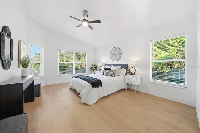 a bedroom with a large bed and a window