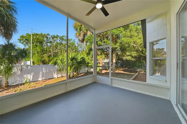a view of a room with a large window and wooden floor