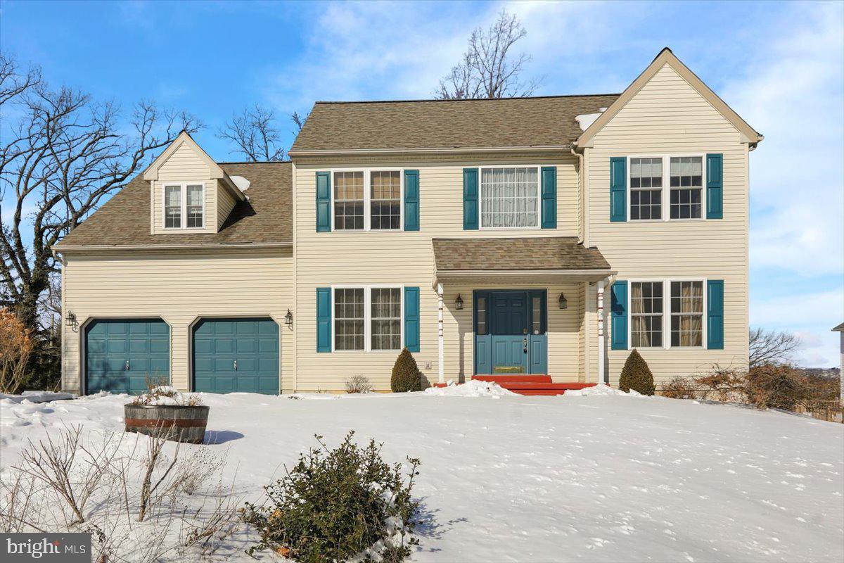 a view of a white house with a yard in front of it