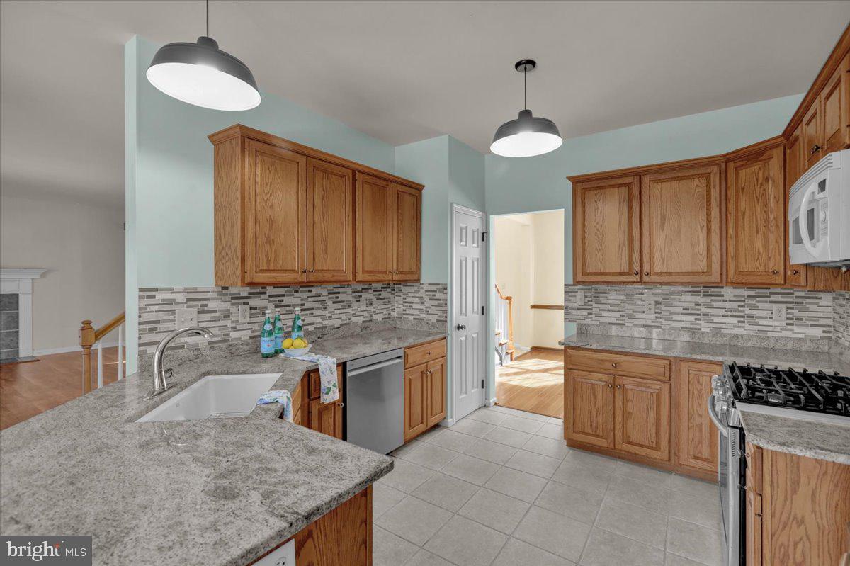 902 Bedford Avenue Reading, PA 19607 - Photo 13 of 48 a kitchen with a stove a sink and a refrigerator