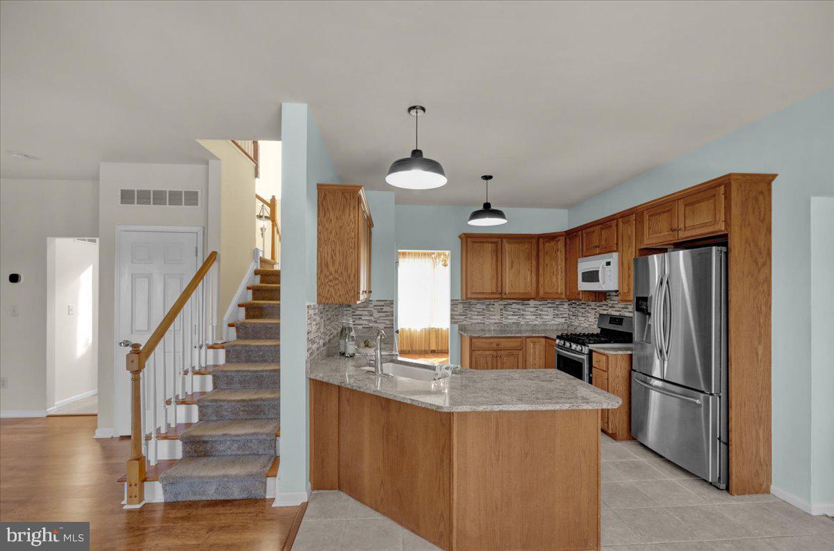 902 Bedford Avenue Reading, PA 19607 - Photo 14 of 48 a kitchen with stainless steel appliances granite countertop a refrigerator a stove and a sink