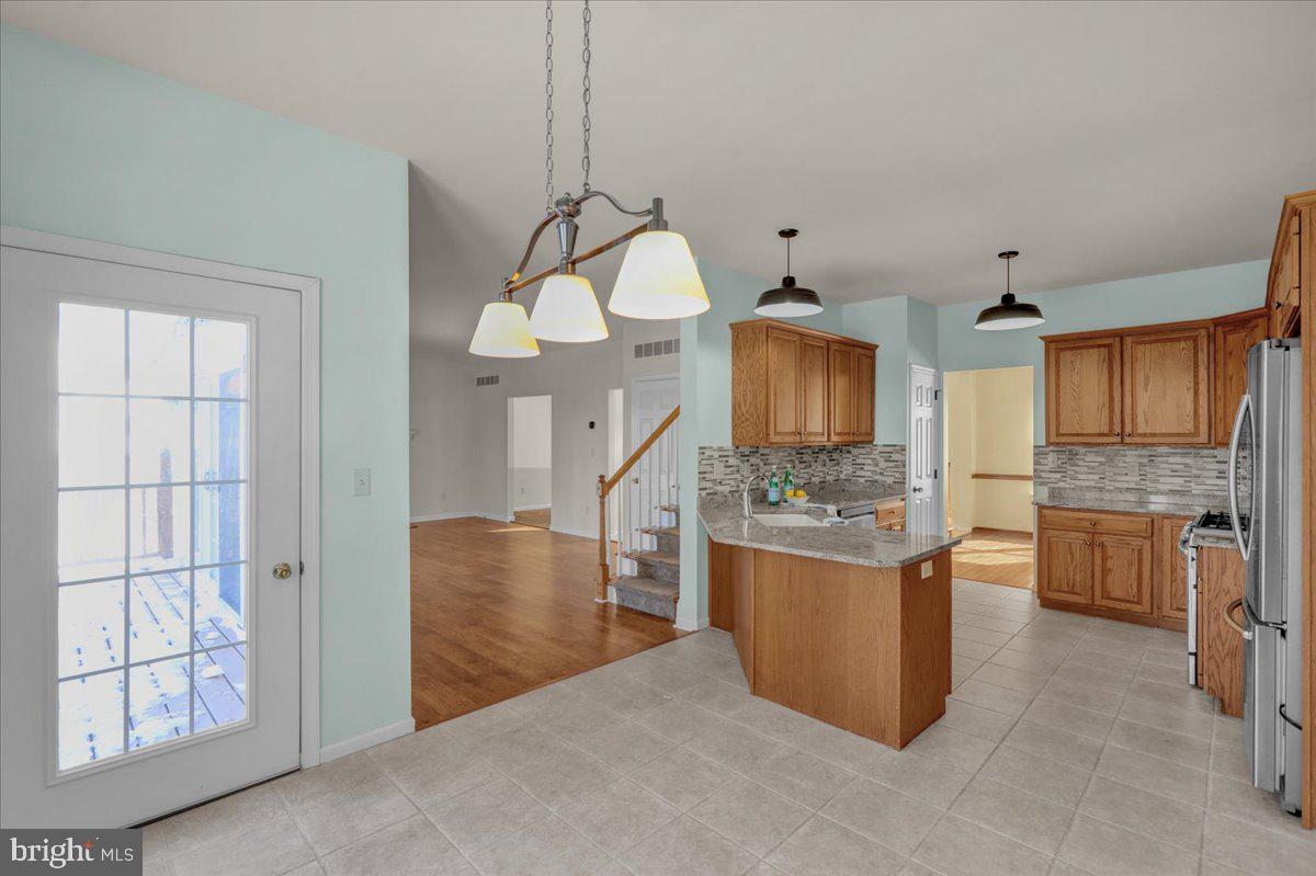 902 Bedford Avenue Reading, PA 19607 - Photo 16 of 48 a kitchen with stainless steel appliances granite countertop a stove and a refrigerator