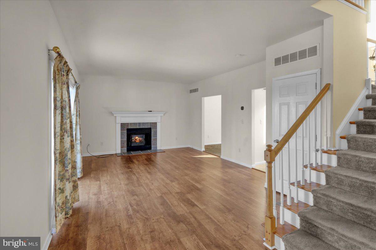902 Bedford Avenue Reading, PA 19607 - Photo 17 of 48 a view of an empty room with wooden floor fireplace and a window