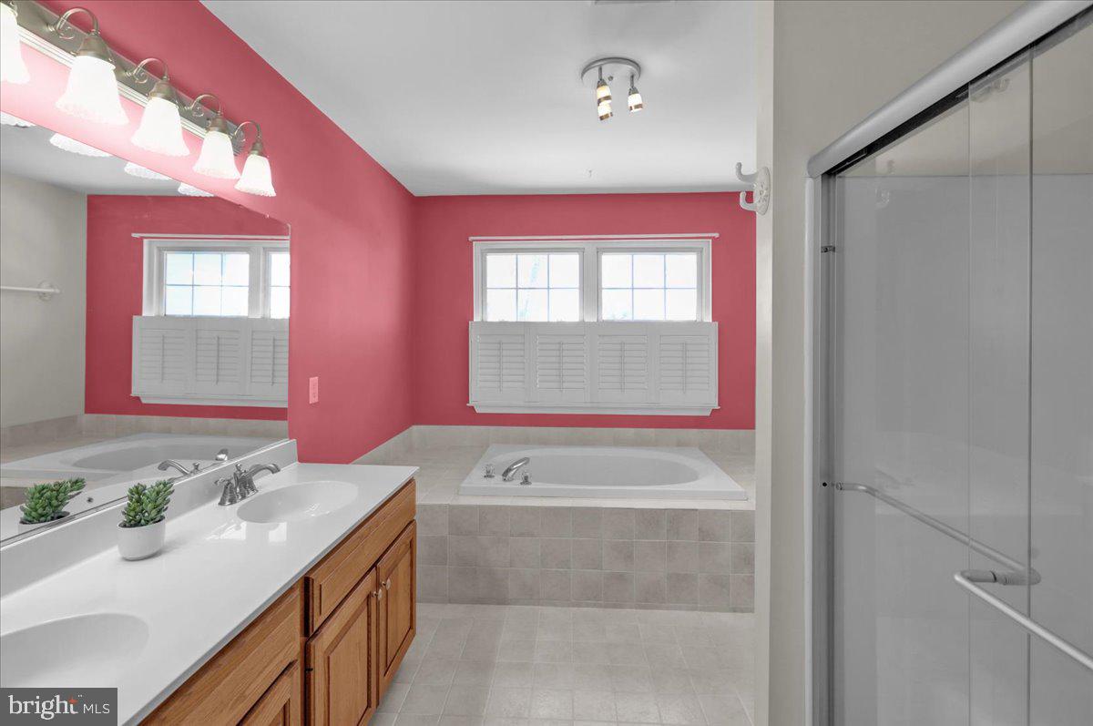 902 Bedford Avenue Reading, PA 19607 - Photo 31 of 48 a bathroom with a bathtub sink vanity and mirror
