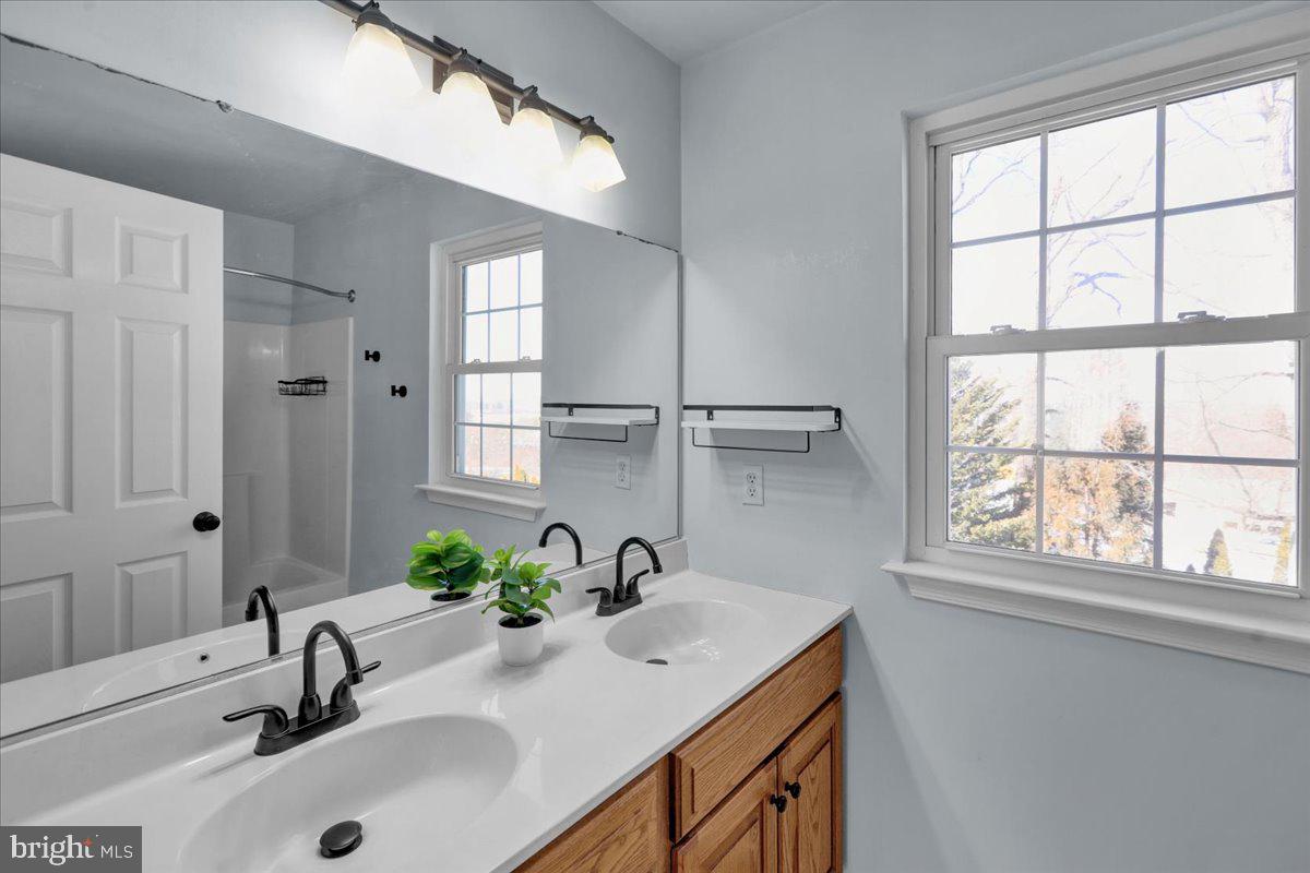 902 Bedford Avenue Reading, PA 19607 - Photo 36 of 48 a bathroom with a sink and a window