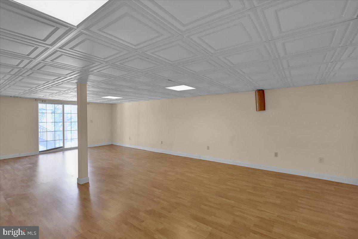 902 Bedford Avenue Reading, PA 19607 - Photo 40 of 48 a view of an empty room with wooden floor and a window