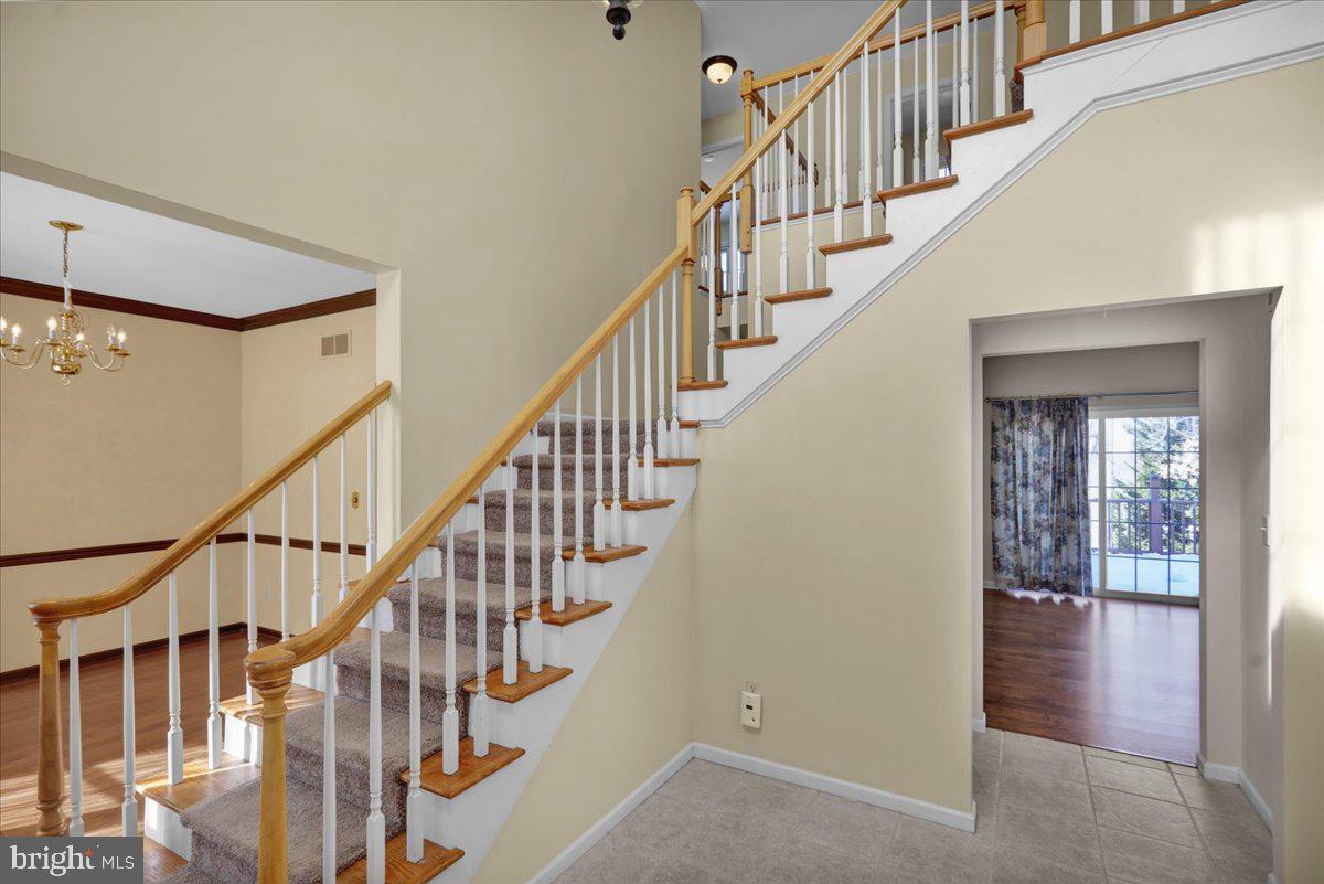 902 Bedford Avenue Reading, PA 19607 - Photo 4 of 48 a view of staircase with lots of frames on wall and a window