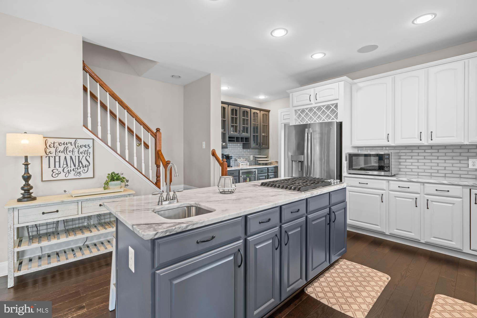 9163 Old Waterloo Road Warrenton, VA 20186 - Photo 12 of 73 a kitchen with a sink stove and cabinets