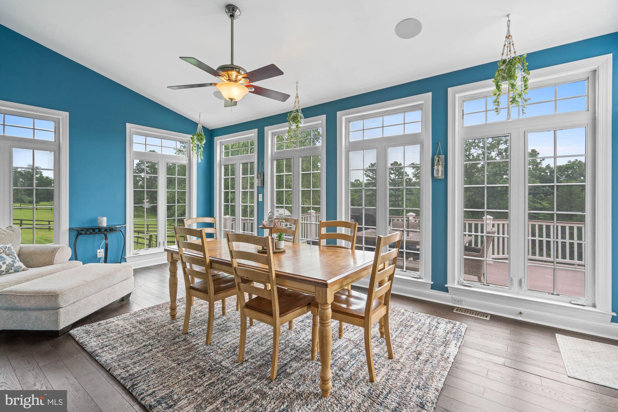 9163 Old Waterloo Road Warrenton, VA 20186 - Photo 13 of 73 a dining room with furniture a chandelier and wooden floor