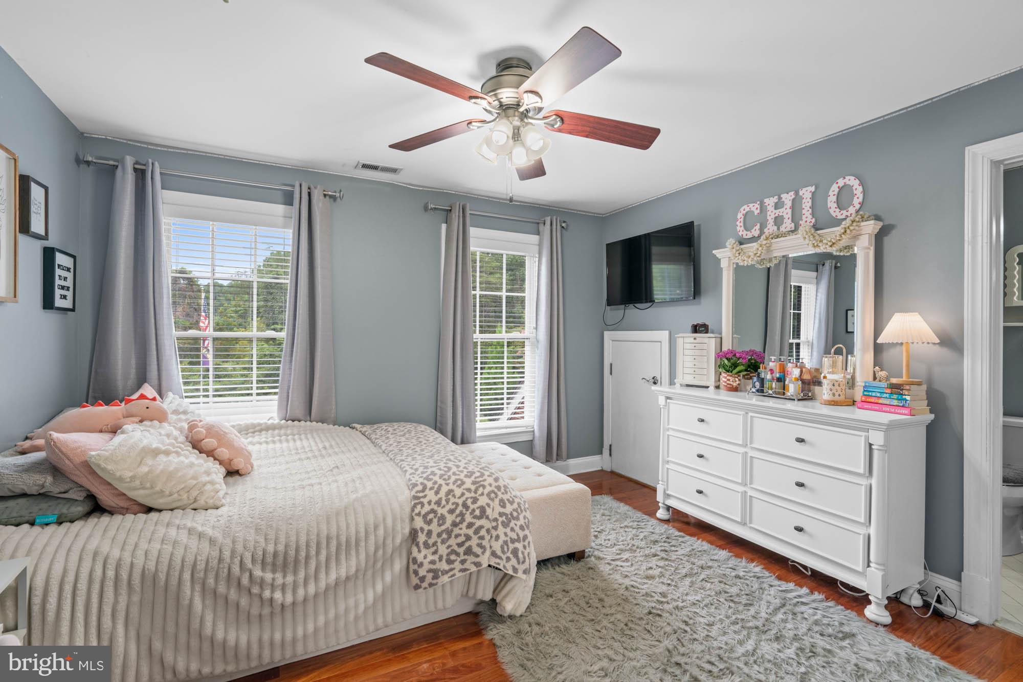 9163 Old Waterloo Road Warrenton, VA 20186 - Photo 29 of 73 a bedroom with a large bed and a flat tv screen on dresser