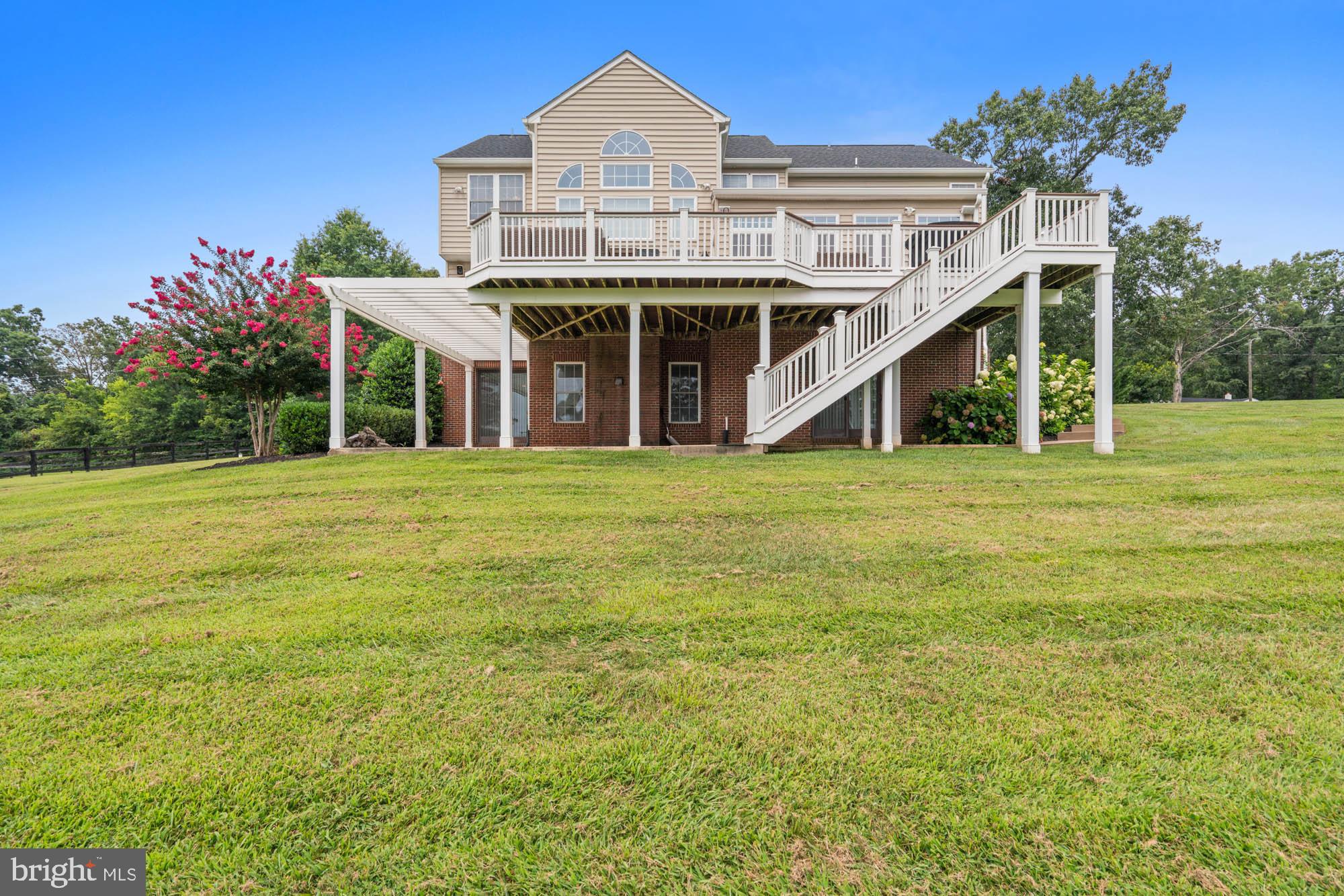 9163 Old Waterloo Road Warrenton, VA 20186 - Photo 48 of 73 a view of a house with a yard and potted plants