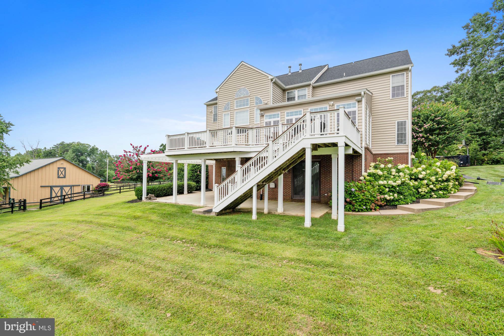 9163 Old Waterloo Road Warrenton, VA 20186 - Photo 49 of 73 a view of a house with a big yard and large trees