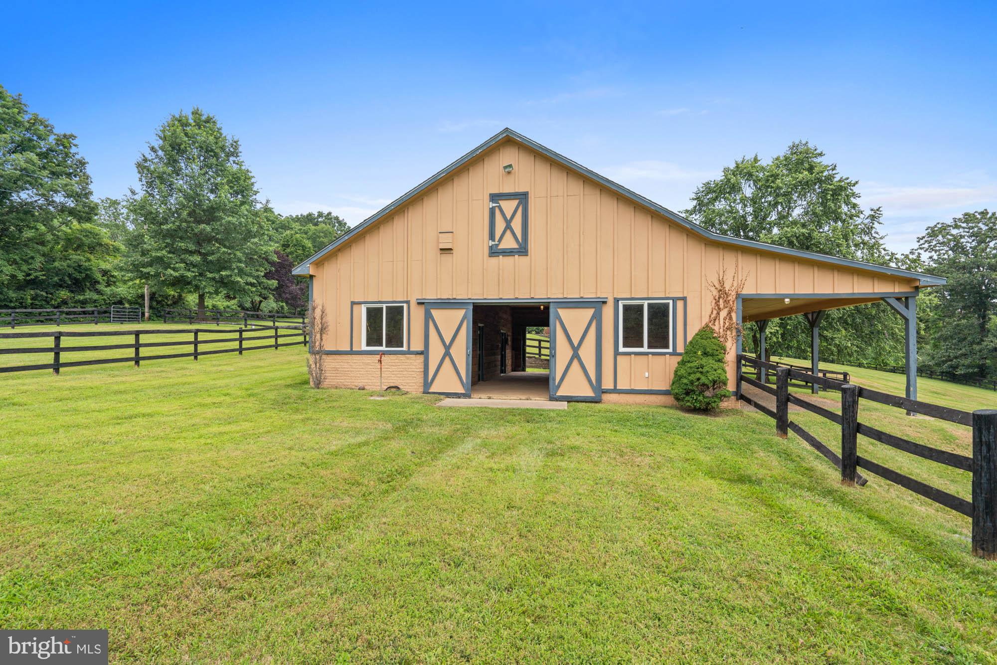 9163 Old Waterloo Road Warrenton, VA 20186 - Photo 62 of 73 a front view of a house with a garden