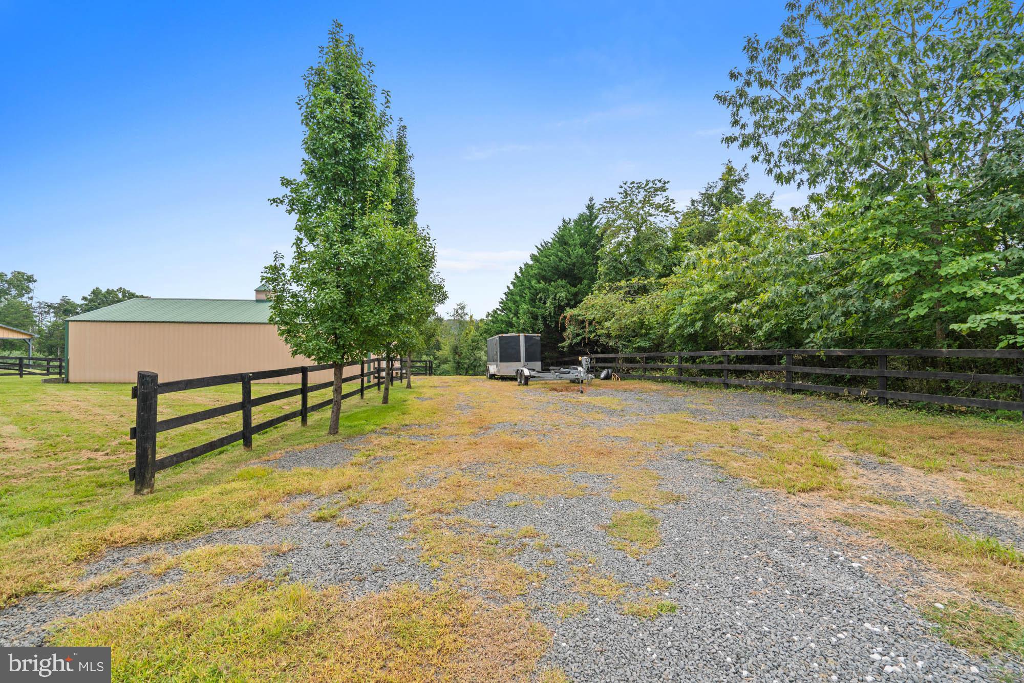 9163 Old Waterloo Road Warrenton, VA 20186 - Photo 68 of 73 a view of a bench in the backyard of a house