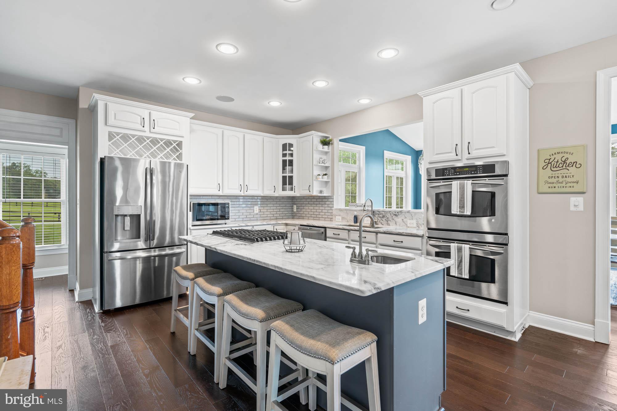 9163 Old Waterloo Road Warrenton, VA 20186 - Photo 9 of 73 a kitchen with stainless steel appliances granite countertop a refrigerator and a stove top oven