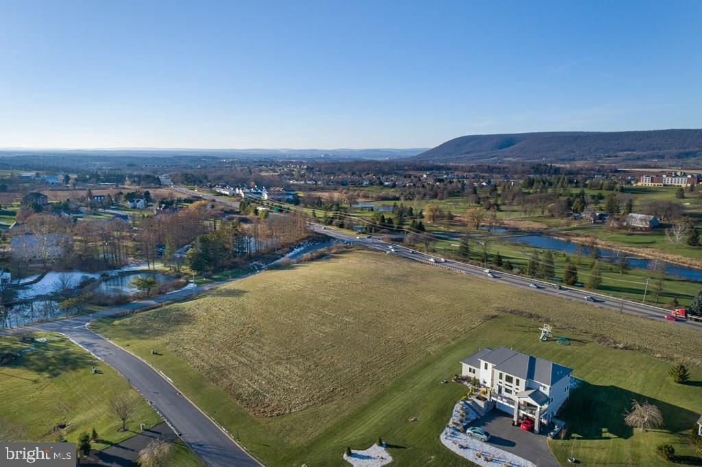 115 Roundhill Road Boalsburg, PA 16827 - Photo 7 of 8 a view of a lake with a mountain
