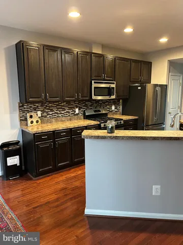 a kitchen with a sink and a stove top oven