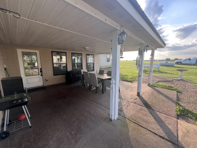 a living room with hardwood floor and a floor to ceiling window
