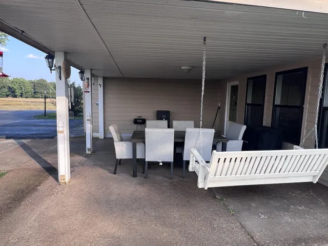 a view of a porch with furniture and a gate