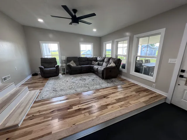 a living room with furniture window and wooden floor