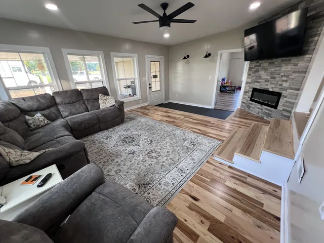a living room with furniture and a flat screen tv