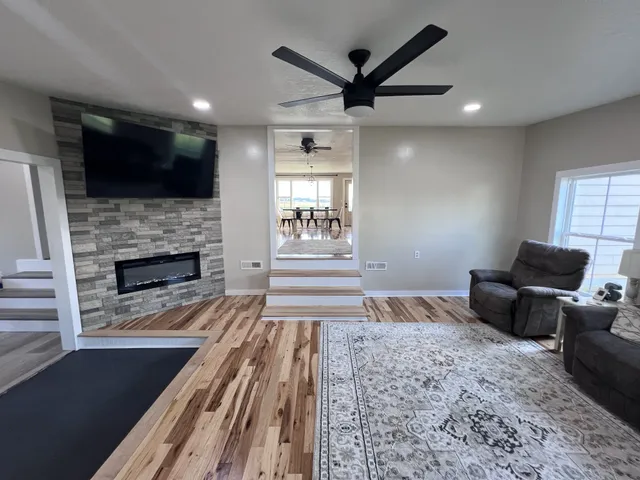 a living room with furniture fireplace and flat screen tv