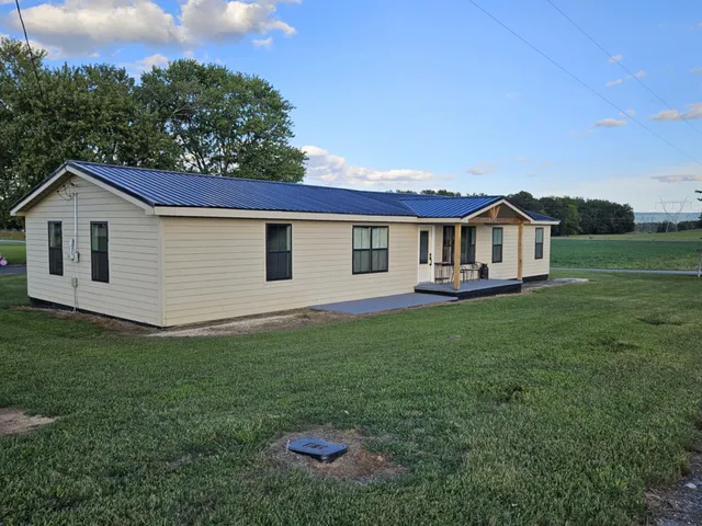 a view of a house with a backyard