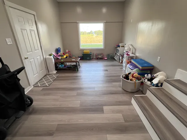 a large bed sitting in a bedroom next to a window