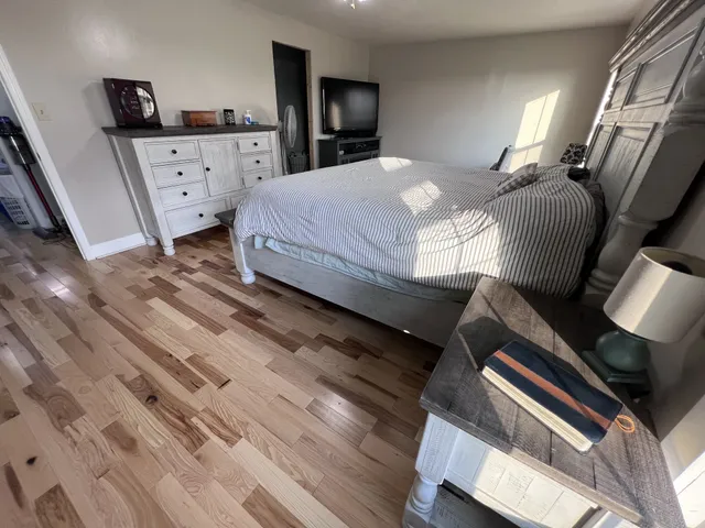 a bedroom with a bed window and couch