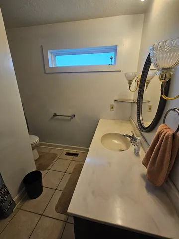 a white toilet sitting next to a bathroom sink