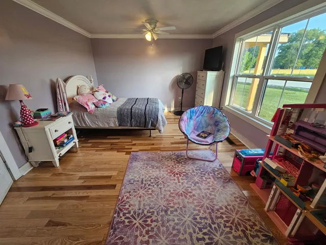 a bedroom with a bed and a flat tv screen