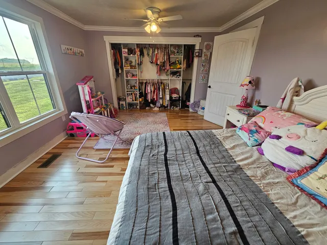 a bedroom with bed and a chandelier