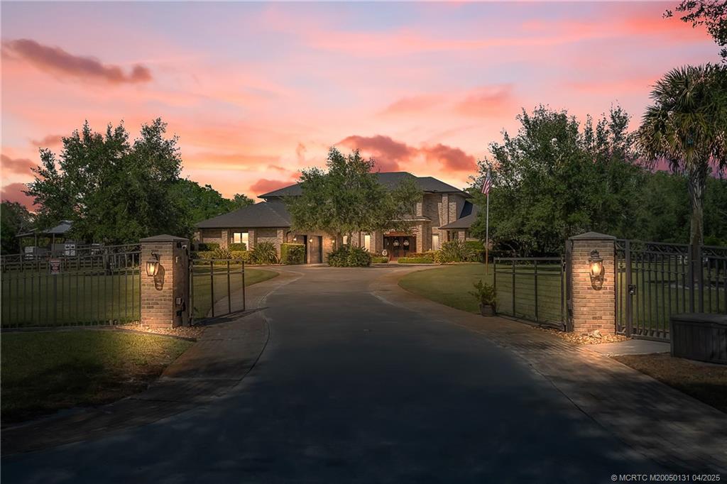 a view of building with river and trees in the background