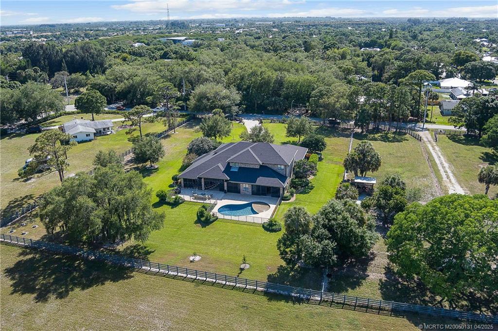 6655 Southwest Gaines Avenue Stuart, FL 34997 - Photo 14 of 48 an aerial view of a house with a garden and swimming pool