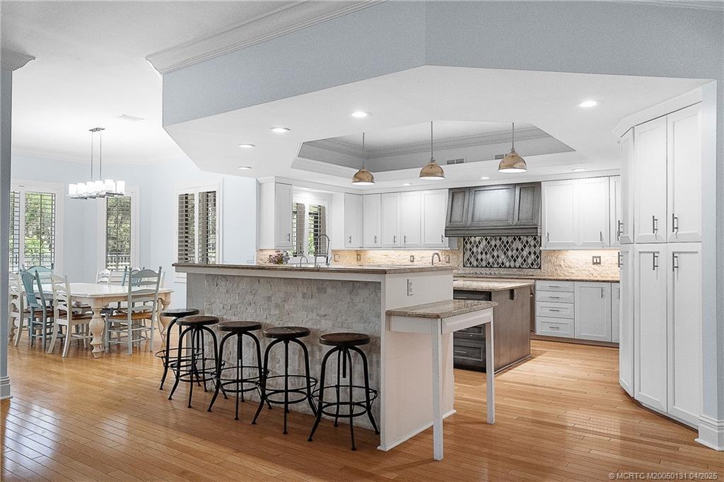 6655 Southwest Gaines Avenue Stuart, FL 34997 - Photo 17 of 48 a large kitchen with a table and chairs in it