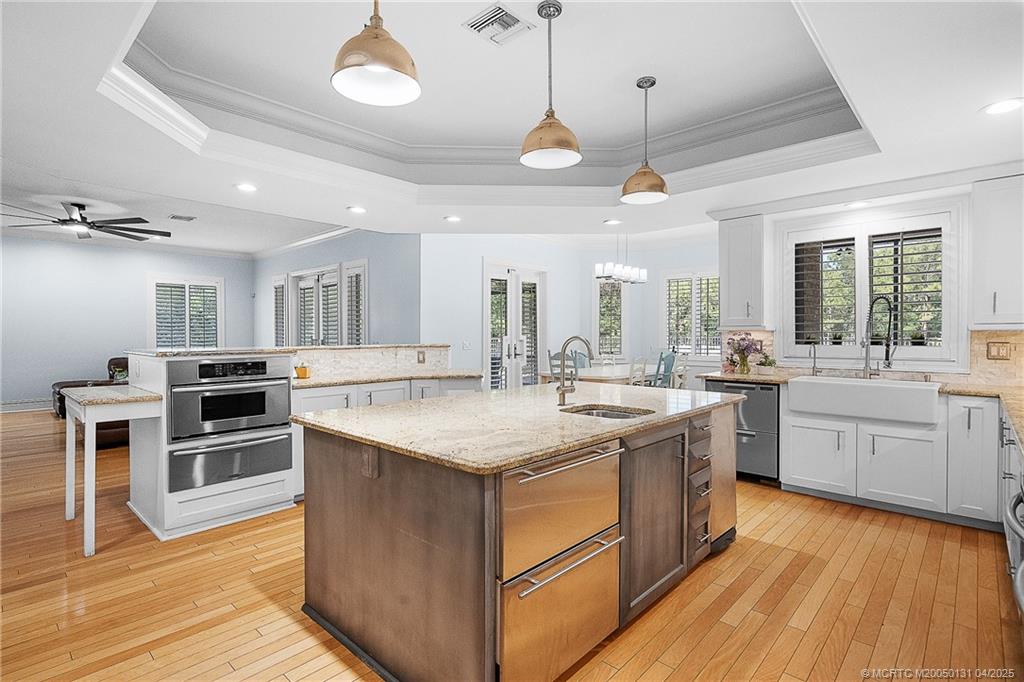 6655 Southwest Gaines Avenue Stuart, FL 34997 - Photo 20 of 48 a kitchen with a stove sink and a refrigerator