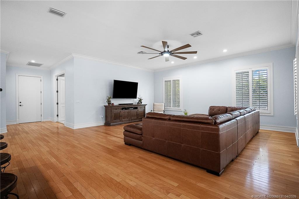 6655 Southwest Gaines Avenue Stuart, FL 34997 - Photo 23 of 48 a living room with furniture and a flat screen tv