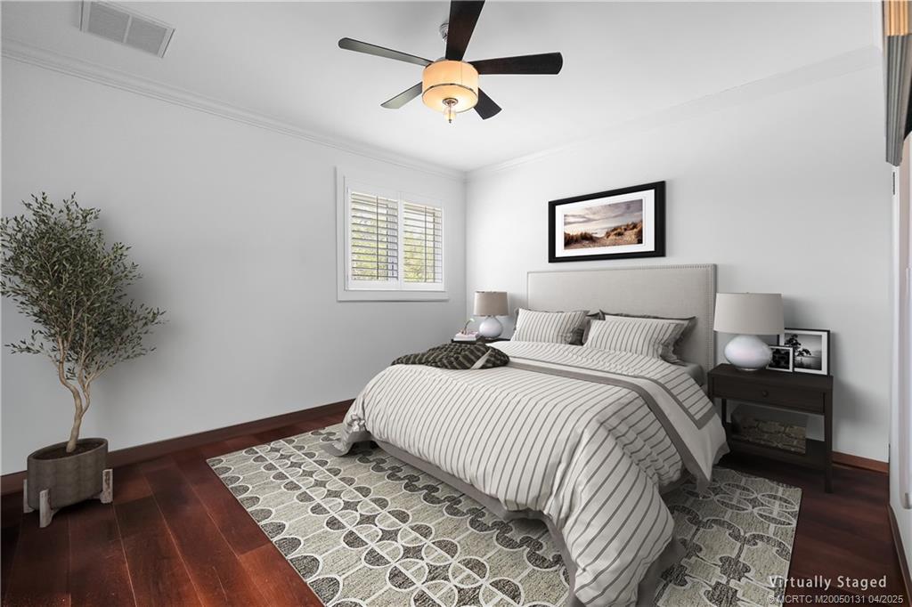 6655 Southwest Gaines Avenue Stuart, FL 34997 - Photo 24 of 48 a bedroom with a bed and a potted plant