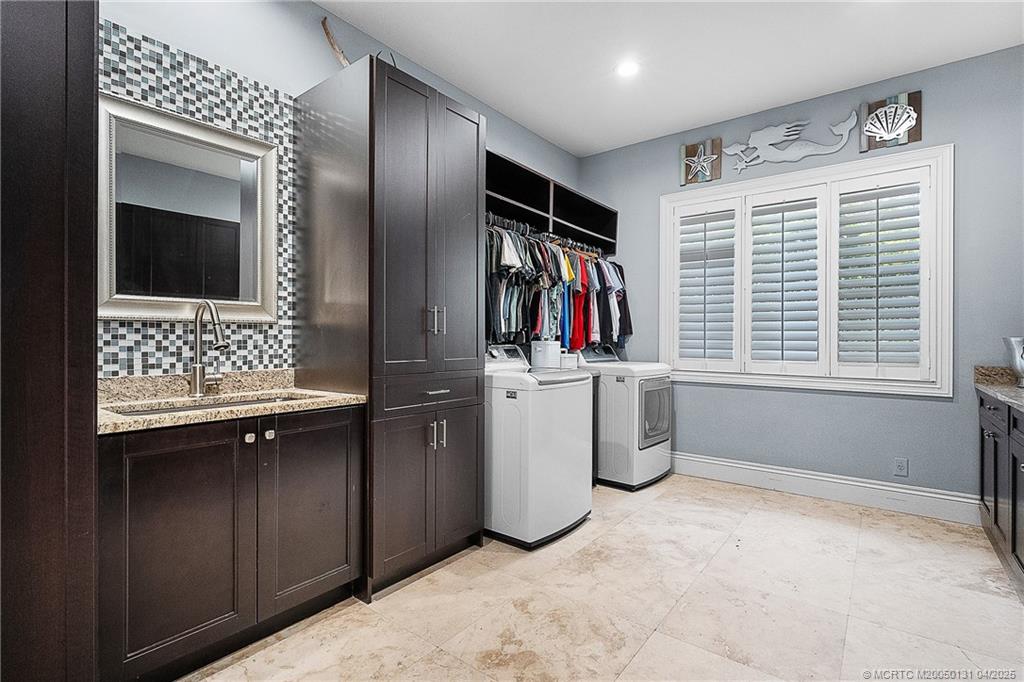 6655 Southwest Gaines Avenue Stuart, FL 34997 - Photo 29 of 48 a view of walk in closet with clothes and shoes