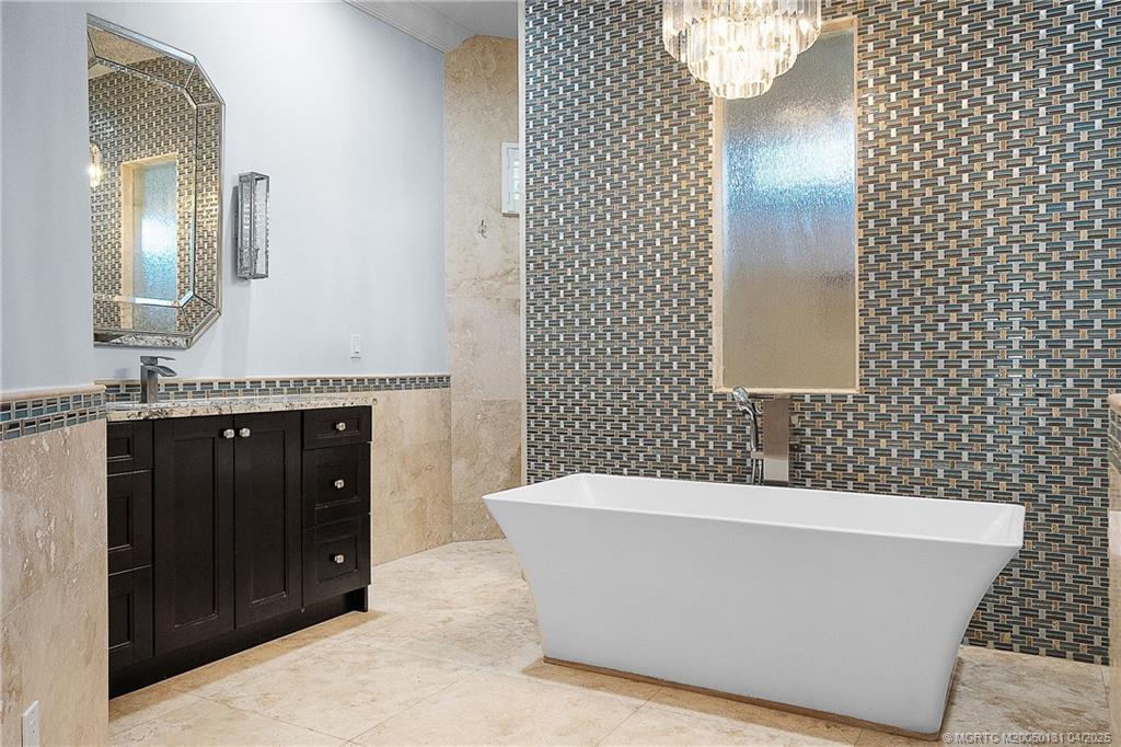 6655 Southwest Gaines Avenue Stuart, FL 34997 - Photo 32 of 48 a view of a bathtub in a bathroom