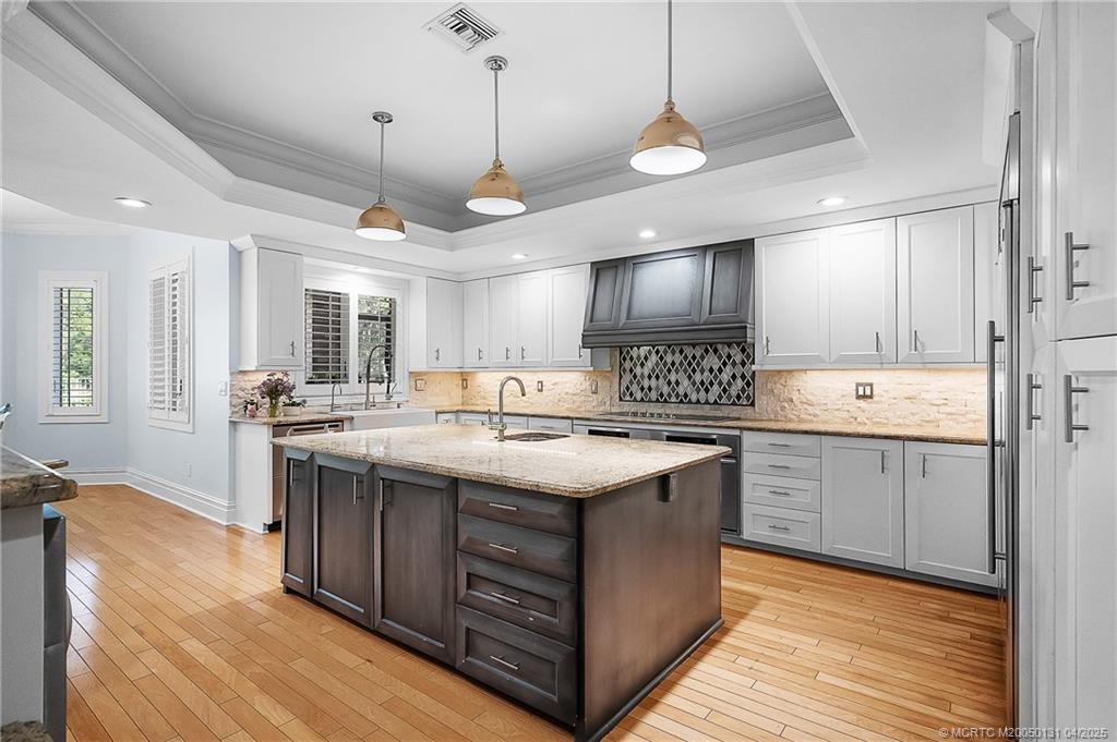 6655 Southwest Gaines Avenue Stuart, FL 34997 - Photo 4 of 48 a kitchen with a sink stove and cabinets